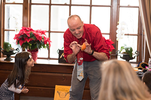 Munsey's Magic performs card in orange routine