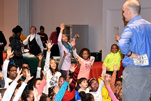 An audience reacts excitedly to Munsey's Magic Show